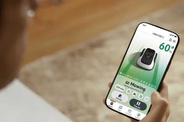 Smartphone app displays mower at 60% with controls for home, pause and scheduling.
