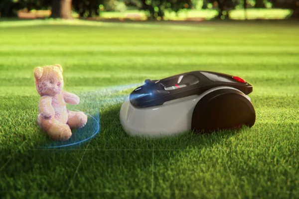 Robotic mower detects teddy bear, blue light shows obstacle avoidance.